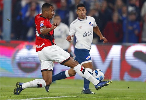 Marlon Freitas of Brazil's Atletico Goianiense, left, fights for the ball with Luis Suarez of Uruguay's Nacional during a Copa Sudamericana quarter-final. (Photo | AP)