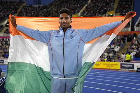 India's Tejaswin Shankar celebrates after taking the bronze medal in the men's high jump during the athletics in the Alexander Stadium. (Photo | AP)
