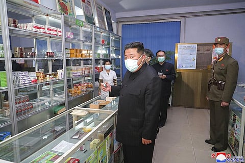 North Korean leader Kim Jong Un, center, visits a pharmacy in Pyongyang. (Photo | AP)