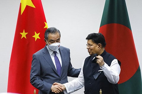 Chinese Foreign Minister Wang Yi, left, stands with his Bangladeshi counterpart A.K. Abdul Momen during their meeting in Dhaka, Bangladesh. (Photo | AP)