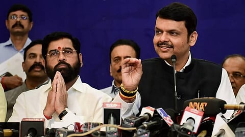 Deputy CM and BJP leader Devendra Fadnavis speaks as Maharashtra CM and Shiv Sena leader Eknath Shinde looks on during a press conference, in Mumbai.