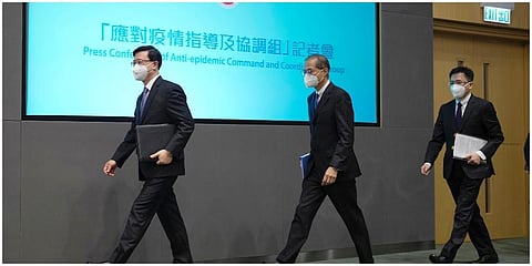 Hong Kong Chief Executive John Lee, left, arrives for a news conference in Hong Kong on Monday. (Photo | AP)