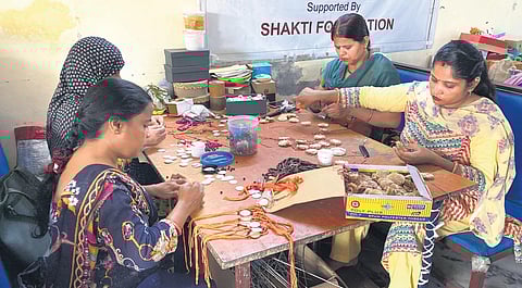 Gulmeher artisans crafting rakhis.