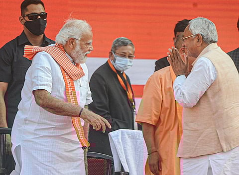 In this Friday, March 25, 2022 file photo, Prime Minister Narendra Modi with Bihar Chief Minister Nitish Kumar during the swearing-in ceremony of UP CM-designate Yogi Adityanath. (Photo | PTI)