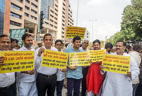 AAP MLA Saurabh Bharadwaj and others gather outside CBI headquarters demanding a probe into the alleged 'Operation Lotus' of BJP. (Photo | PTI)