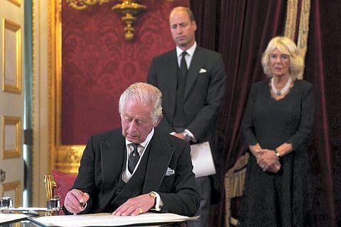 King Charles III signs an oath to uphold the security of the Church in Scotland during the Accession Council at St James's Palace, London. (Photo | AP)