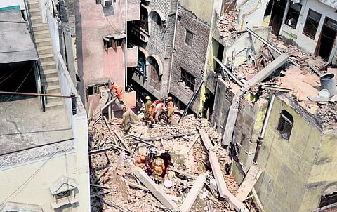 Rescue operation underway after a four-storey under-construction building collapsed in Azad Market on Friday. (Photo | Parveen Negi)
