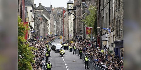 The hearse carrying the coffin of Queen Elizabeth II, draped with the Royal Standard of Scotland, passes along Canongate towards the Royal Mile. (Photo | AP)