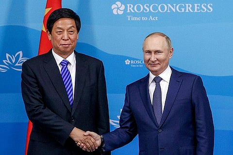 Russian President Vladimir Putin, right, with Chairman of National People's Congress Li Zhanshu . (Photo | AP)