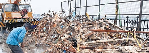 A worker collects debris and idol remnants at Tank Bund in Hyderabad on Sunday | RVK Rao