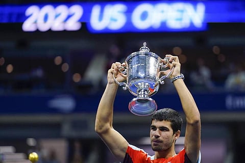 Champ at 19: Carlos Alcaraz, of Spain, holds up the championship trophy after defeating Casper Ruud, of Norway. (AP)