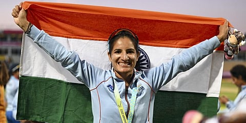 Indian cricket team player Renuka Singh holds a tricolor after the medal ceremony at the Commonwealth Games 2022.(Photo | PTI)