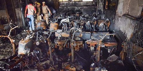Hyderabad Police and members of their Clues team at the electric bike showroom that caught on fire Tuesday, Sept. 13, 2022. (Photo | PTI)