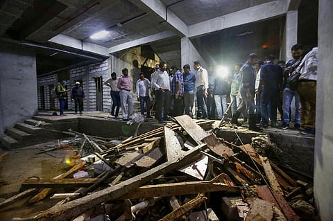 Debris lie on the ground after the elevator of an under-construction building crashed, in Ahmedabad on September 14, 2022. (Photo | PTI)