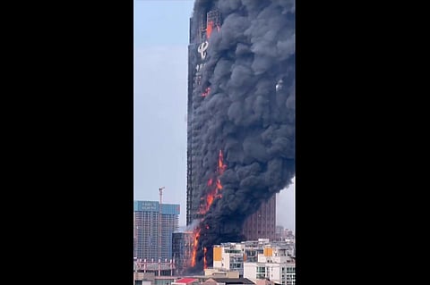 This screengrab taken from a video provided to AFPTV by an anonymous source on September 16, 2022 shows thick smoke billowing from a skyscraper in Changsha, in China. (Photo |AFP)