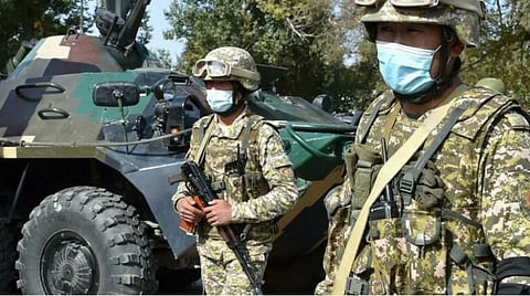 File photo of Kyrgyz servicemen at a checkpoint on the outskirts of Bishkek. Vyacheslav Oseledko. (Photo | AFP)