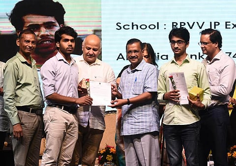 Delhi Chief Minister Arvind Kejriwal felicitates students of Delhi government schools who topped in JEE and NEET exams (Photo | Express)