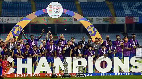 Bengaluru FC players pose with the Durand Cup-2022 trophy after defeating Mumbai City FC by 2-1, at Vivekananda Yuba Bharati Krirangan stadium , in Kolkata. (Photo | PTI)