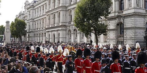 The coffin of Queen Elizabeth II is pulled on a gun carriage through the streets of London following her funeral service at Westminster Abbey. (Photo | AP)