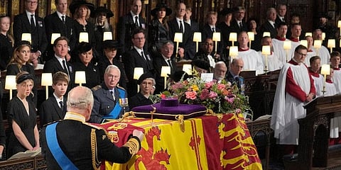 King Charles III places the Queen's Company Camp Colour of the Grenadier Guards on the coffin at the Committal Service for Queen Elizabeth II. (Photo | AP)