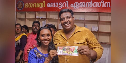Anoop B and his wife Maya with the winning lottery ticket on Sunday | B P Deepu