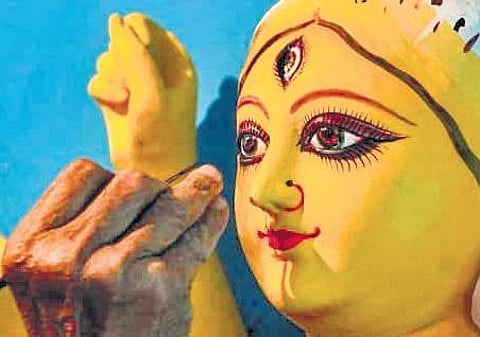 An artist gives final touches to an idol ahead of Durga Puja | PTI