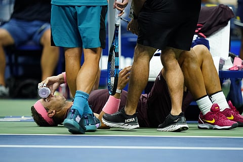 Rafael Nadal, of Spain, holds a bottle to his face during a medical timeout during a match. (Photo | AP)