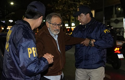 Police escort Juan Percowicz to serve pre-trial detention, Aug. 30, 2022. Authorities have identified Percowicz, 84, as the leader of the sect-like Buenos Aires Yoga School. (Photo | AP)