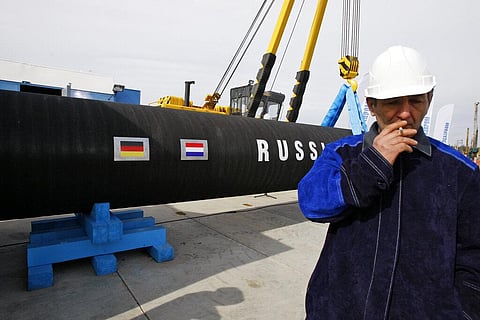 A Russian construction worker smokes in Portovaya Bay some 170 kms (106 miles) north-west from St. Petersburg, Russia, on April 9, 2010. (Photo | AP)