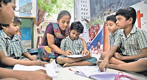 An Illam Thedi Kalvi volunteer teaching students at Kodambakkam in Chennai on Monday | KARTHIK SARAN