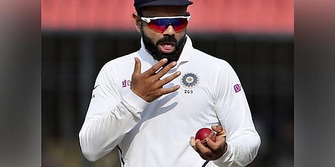 Cricketer Virat Kohli shining the ball. (File Photo | AP)