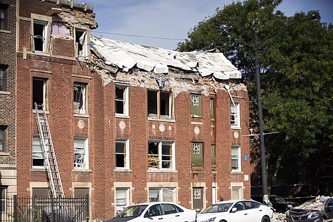 Damage is seen where an explosion tore through the top floor of an apartment building at the corner of Wend Wen Avenue and N Central Avenue in Chicago's South Austin neighborhood. (Photo | AP)