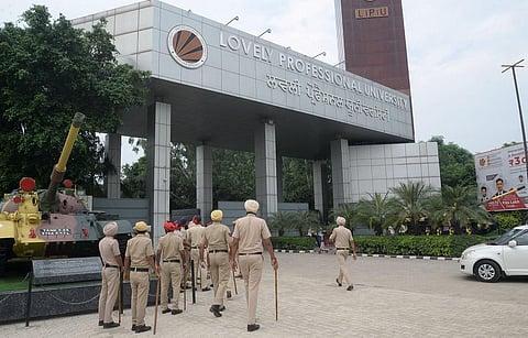 Police personnel keep vigil outside Lovely Professional University, after protests erupted on Tuesday night in Jalandhar on Wednesday. (Photo | PTI)