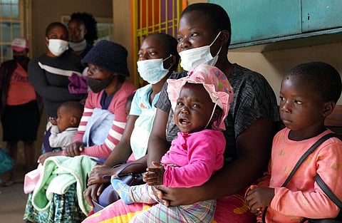 Women holding babies take their places on wooden benches at a clinic in Harare, Zimbabwe, Thursday, Sept. 15, 2022.(Photo | AP)