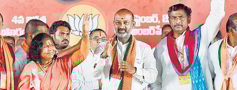 Minister of State for Rural Development Sadhvi Niranjan Jyothi, BJP State president and Karimnagar MP Bandi Sanjay Kumar and party general secretary P Muralidhar Rao wave at the public in Pedda Amberp