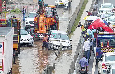 A vehicle stuck on the waterlogged Delhi-Gurugram Expressway service road following heavy rains in Gurugram on Friday | PTI