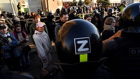A police officer, with the 'Z' tactical insignia of Russian troops in Ukraine on his helmet, blocks the street in Saint Petersburg on September 24. (Photo | AFP)