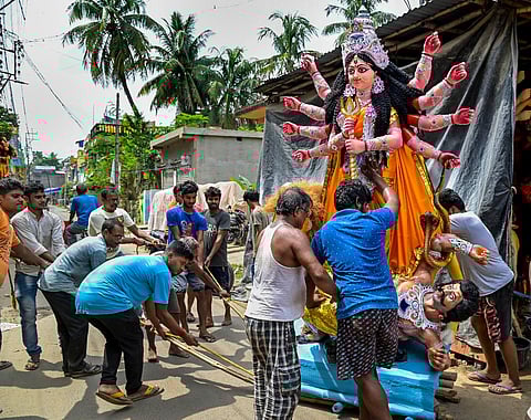 A clay model of Goddess Durga being loaded into a lorry for transportation to Kolkata, ahead of the Durga Puja celebrations, in Nadia. (Photo | PTI)