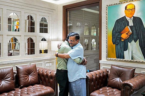 Sanitation worker Harsh Solanki from Gujarat meets Delhi Chief Minister Arvind Kejriwal at his residence, in New Delhi. (Photo | PTI)