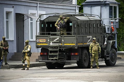 Russian soldiers guard an area as a group of foreign journalists visit in Kherson, Kherson region, south Ukraine, May 20, 2022. (Photo | AP)