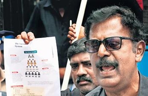 A member of Thanthai Periyar Dravidar Kazhagam shows the textbook’s content in Coimbatore | S Senbagapandiyan