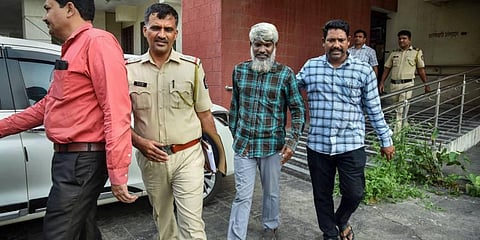 A member of Popular Front of India (PFI) being taken to custody in Navi Mumbai. (Photo | PTI)