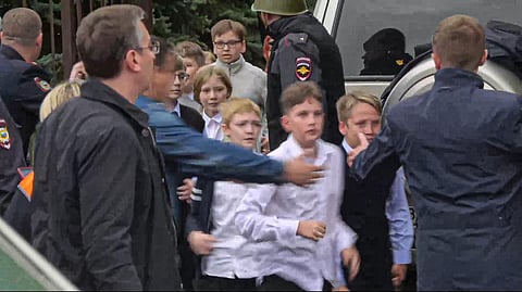 In this image taken from video, school children run from the scene of a shooting at school No. 88 in Izhevsk, Russia, on September 26, 2022. (Photo | AP)
