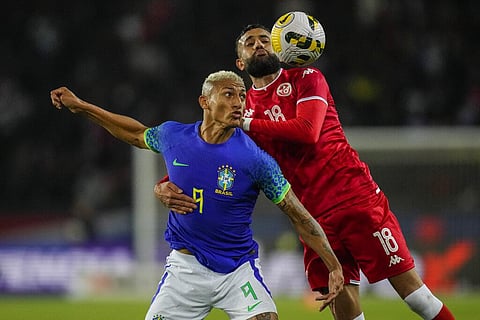 Tunisia's Ghaylen Chaaleli duels for the ball with Brazil's Richarlison during the international friendly soccer match between Brazil and Tunisia at the Parc des Princes stadium. (Photo | AP)
