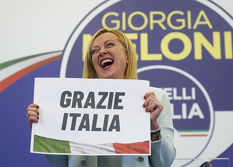 Far-Right party Brothers of Italy's leader Giorgia Meloni shows a placard reading in Italian 'Thank you Italy' at her party's electoral headquarters in Rome. (Photo | AP)