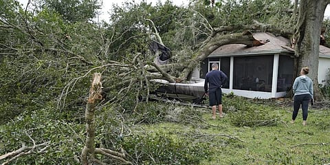 People survey damage to their home in the aftermath of Hurricane Ian. (Photo | AP)