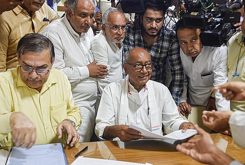 Senior Congress leader Digvijaya Singh collects nomination form for the post of party president, at AICC headquarters in New Delhi on Thursday. (Photo | PTI)