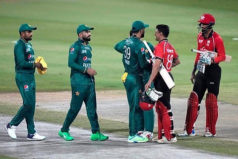 Hong Kong's Ehsan Khan, second right, and Mohammad Ghazanfar shake hand with Pakistani players on the end of the T20 cricket match of Asia Cup. (Photo | PTI)