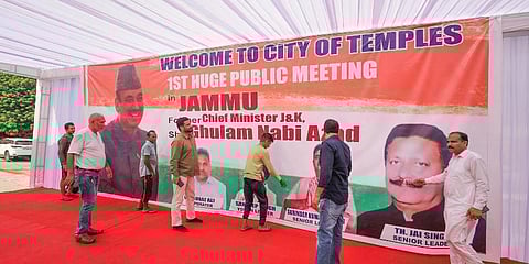 Supporters install a hoarding of former J&K chief minister Ghulam Nabi Azad ahead of his public meeting, in Jammu. (Photo |PTI)