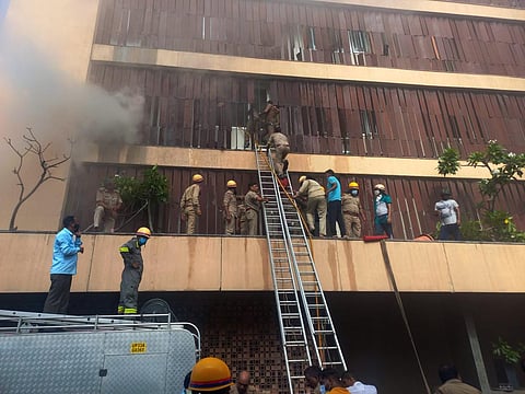 Fire Brigade personnel try to evacuate people after a fire broke out in a hotel in Hazratganj area of Lucknow, Monday, Sept. 5, 2022. (Photo | PTI)